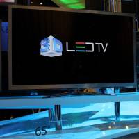 A television on top of a two level glass table
